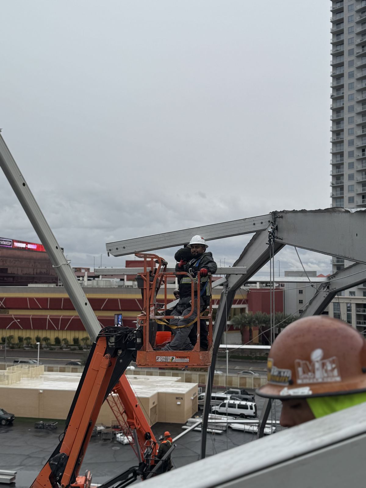 Crew installing structure components from a lift