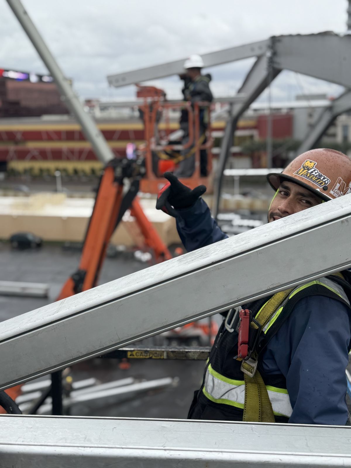 Crew lead working from a lift on a structure frame