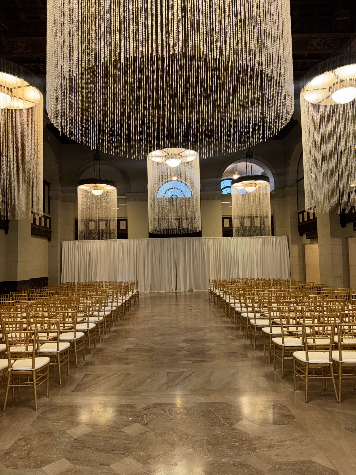 Event setup with chair rows and chandeliers